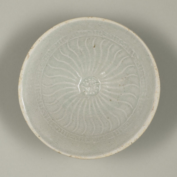 Bowl with Molded Flower at Center and Wavy Lines on Inside