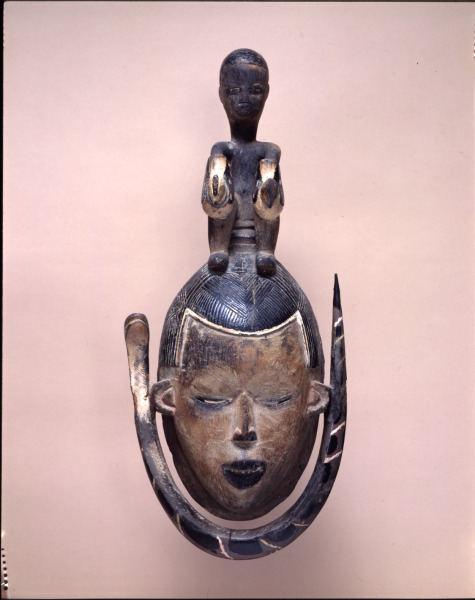 Female Mask Surmounted by a Seated Figure