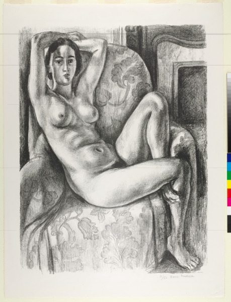 NUDE WITH BLUE CUSHION NEXT TO A FIREPLACE