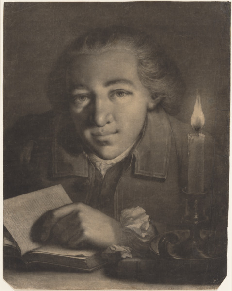 YOUNG MAN FACING FRONT WITH AN OPEN BOOK AND CANDLE