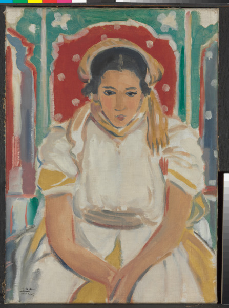 GIRL IN WHITE DRESS SEATED IN RED CHAIR