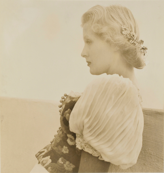 PROFILE OF A YOUNG WOMAN WITH FLOWERS IN HER HAIR