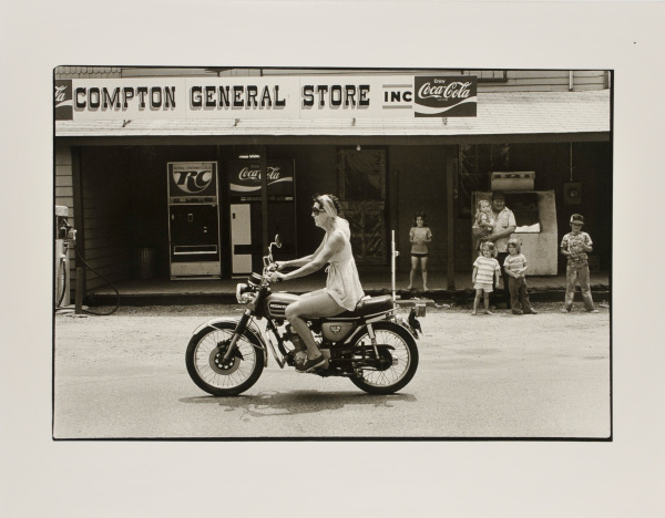 WOMAN ON MOTORCYCLE, COMPTON.