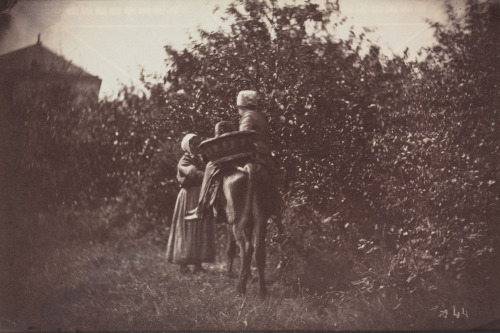 TWO PEASANT WOMEN, ONE RIDING DONKEY