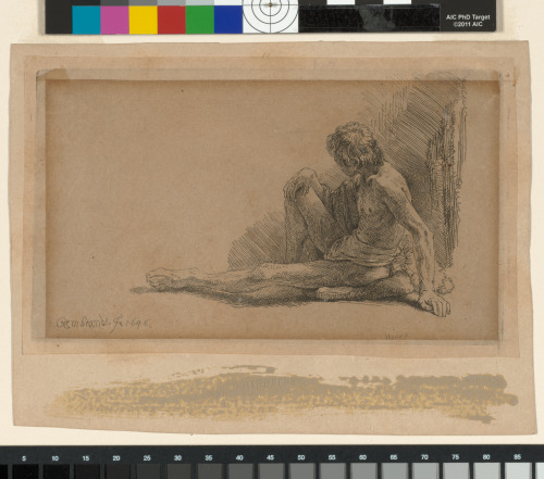 NUDE MAN SEATED ON THE GROUND WITH ONE LEG EXTENDED