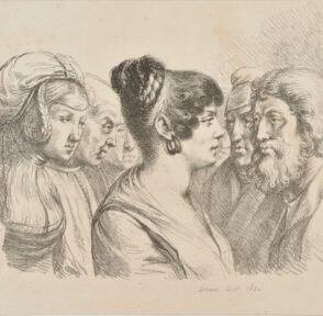 Woman seen from the right standing among a group of men with another woman behind her.