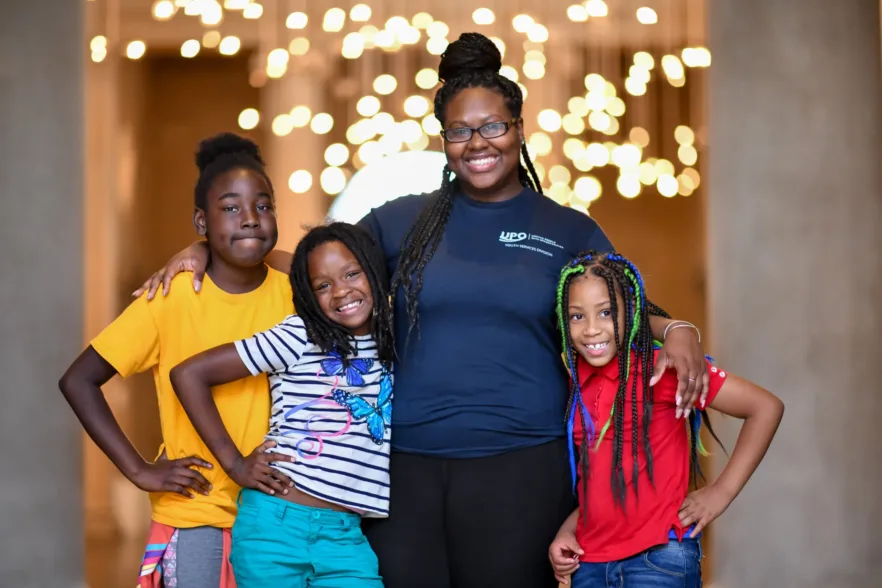 A family smiles for a group photo at the Baltimore Museum of Art.